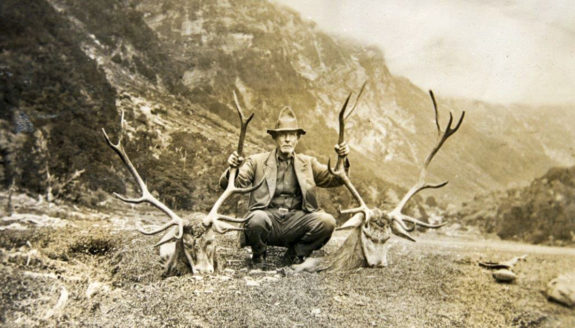 On a tiny saddle in the Blue Valley, Clem Anderson sits and holds a 10- and 11-pointer after the afternoon stalk